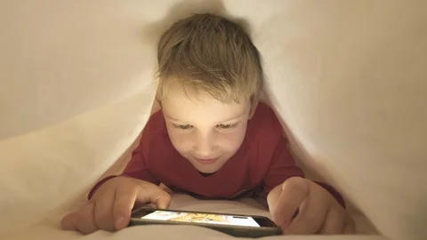 Boy using smartphone to video call a friend Stock Footage 95452001