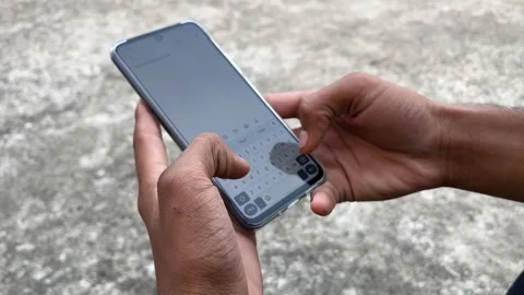 Boy Using Smartphone While Typing – Mobile Interaction Close-Up in 4K Видео 321515542