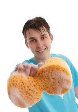 Boy using a soapy sponge to clean Stock Photos