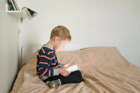 Boy using tablet on bed Stock Photos
