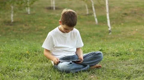 Boy using tablet computer outdoors. Thumbs up. Ok. 動画素材 11619331