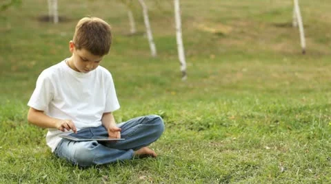 Boy using tablet computer outdoors Video stock 11619356