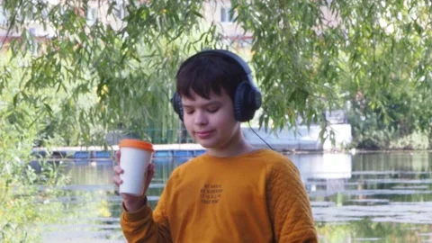 Boy using tablet computer, teenager relaxing in the park Stock Footage 270937110