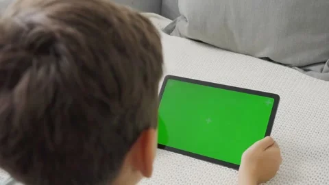 Boy Using Tablet with Green Screen and Browsing Internet Chroma Key Stock-Footage 257001751