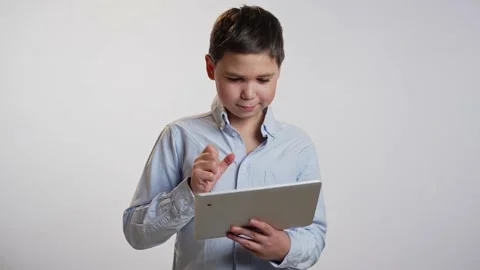Boy using tablet pc on white background Video stock 239625809