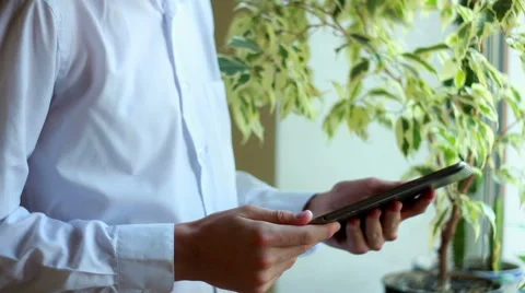 Boy Using Tablet Standing By The Window Stock Footage 40499757