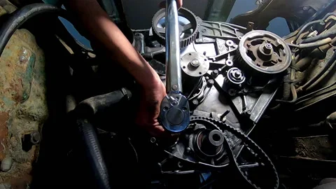 Boy using torque wrench on the timing sprockets of the engine belts Video stock 171863487