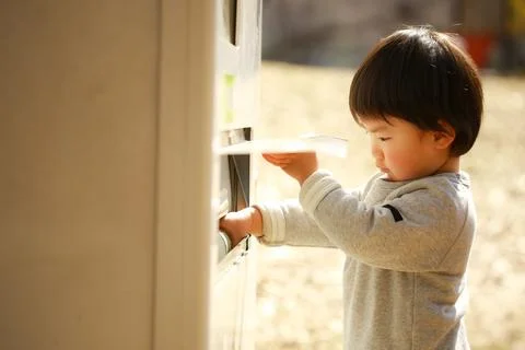 Boy using vending machine Stock Photos