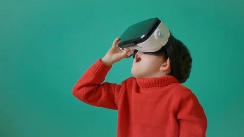 Boy using virtual reality headset with surprise expression. Stock Footage 104925636