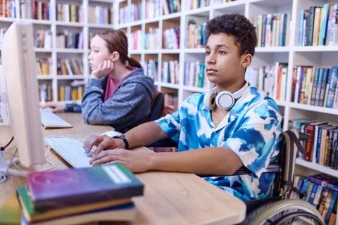 Boy using wheelchair in computer class 스톡 사진