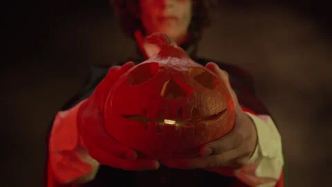 Boy in Vampire Costume Holding Glowing Carved Halloween Pumpkin Stock Footage 341673580