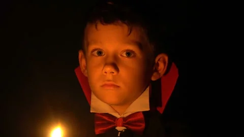 Boy in vampire costume posing for camera, makeup as evil spirits on Halloween Stock Footage 98001904