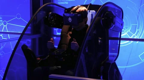 A boy in the virtual reality chair with HMD on his head Vídeos de archivo 67251328