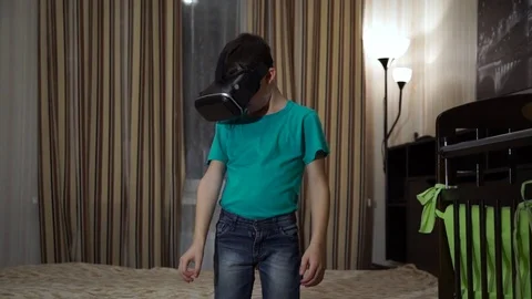 The Boy in the Virtual Reality Device in the Badroom Video stock 70065669