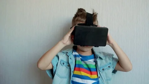 Boy in virtual reality glasses playing the game, focus on face Video stock 70577958