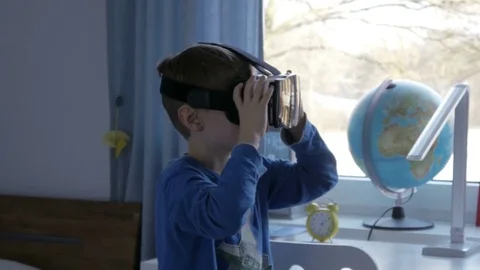 Boy in virtual reality glasses playing 360 degree game - 4k Stock Footage 80263050