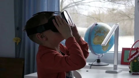 Boy in virtual reality glasses watching 360 degree video - 4k Stock Footage 80266647