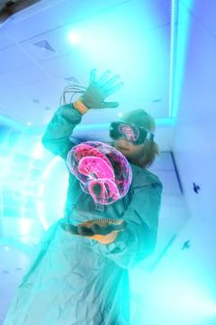 Boy in virtual reality headset interacting with digital floating human brain Stock Photos