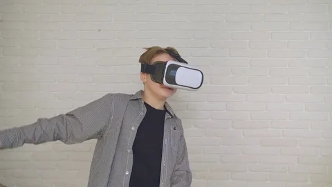 Boy in VR glasses. closeup shot. The boy looks emotionally virtual glasses. 4K Stock Footage 83852196