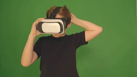 Boy in VR glasses. closeup shot. The boy looks emotionally virtual glasses Stock Footage 84634674
