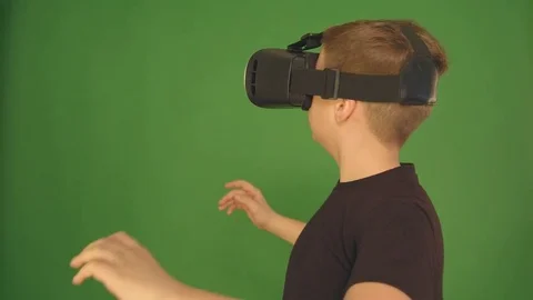 Boy in VR glasses. closeup shot. The boy looks emotionally virtual glasses Stock Footage 84635920