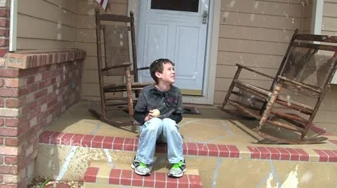 Boy waiting for snow to stop 1 Stock Footage 10890919