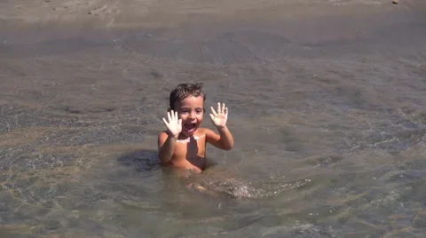 Boy waits for waves with awe Stock Footage