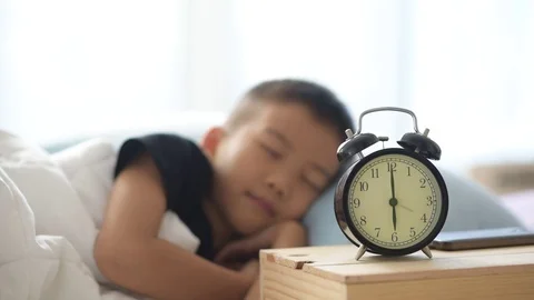 Boy wake up by clock Stock Footage 70013846