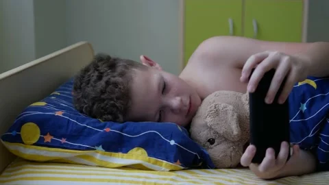 Boy with wake up took out mobile phone Stock Footage 147021258