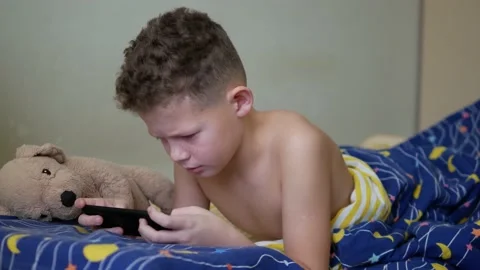 Boy wake up took out mobile phone Stock Footage 147034475