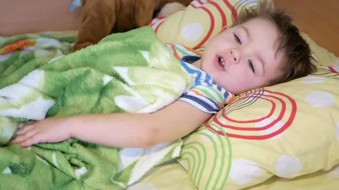 Boy wakes up and looks at camera smiling happily. Stock Footage 149109790