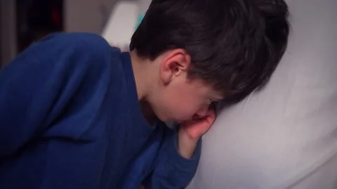 Boy waking up while yawning in bed, capturing authentic morning routine, he.. Stock Footage 340967803