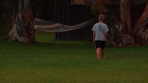 Boy walking across yard Video stock 63931417