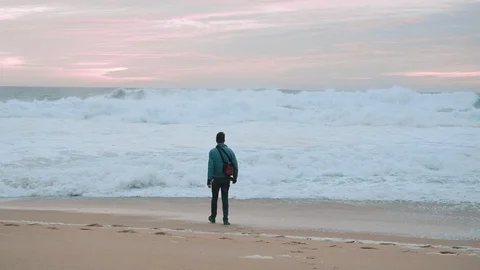 Boy Walking Alone On Empty Seashore In Cloudy Cold Weather. Boy Rides To Meet Stock-Footage 107738577