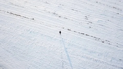 Boy Walking Alone in Snow Covered Field Video stock 114889669