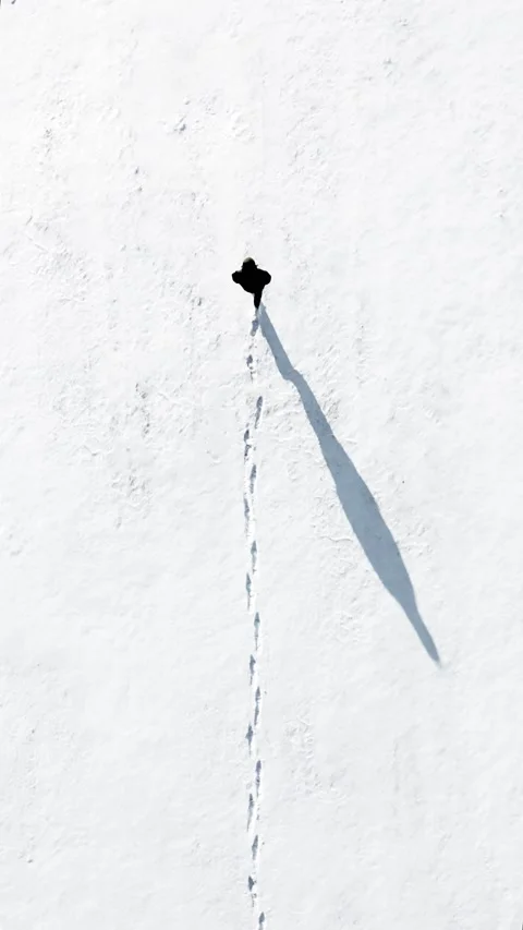 Boy Walking and Making Footprints in the Snow Stock Footage 148884722