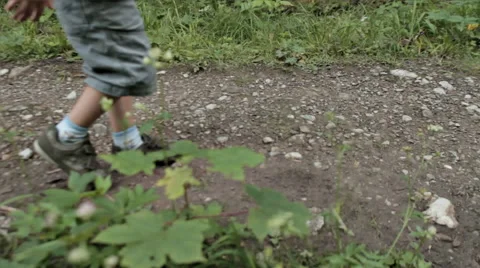 BOY WALKING AND RUNNING THROUGH THE STONES Stock Footage 68755892
