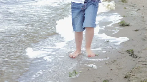 A Boy is Walking on the Beach Stock Footage 68666635