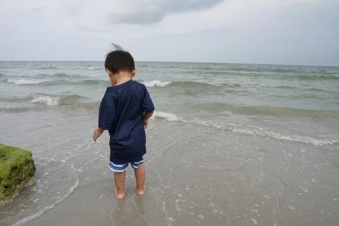 A boy walking on the beach Stock Photos
