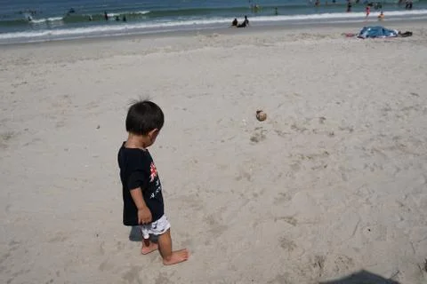 A boy walking on the beach Stock Photos