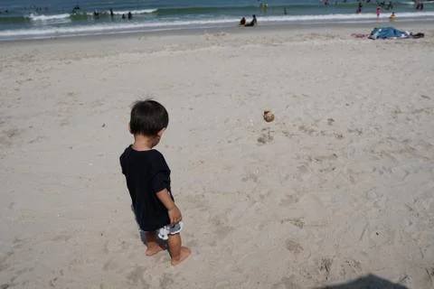A boy walking on the beach Stock Photos