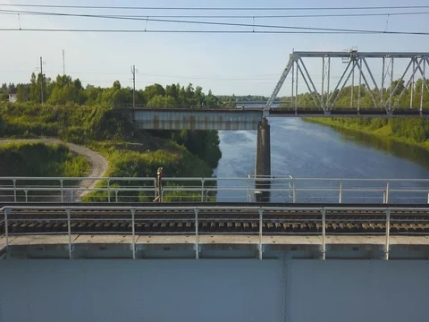 Boy Walking On Bridge Over The River Video stock 79498207