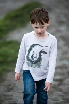 Boy walking up the Cliffs of Moher Tourist Attraction in Ireland Stock Photos