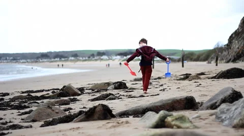 Boy walking down beach Stock Footage 46628280