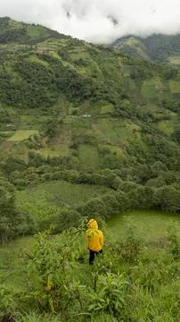 Boy walking down a mountain hill Stock Photos