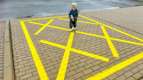 Boy walking on empty parking lot or space on the urban street in the city Stock Photos