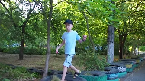 Boy walking on old car tires Stock Footage 201837289