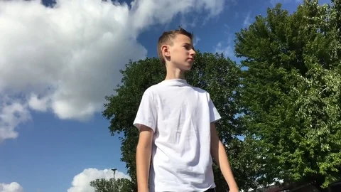 Boy Walking in Slow Motion from Below 스톡 동영상 79630383