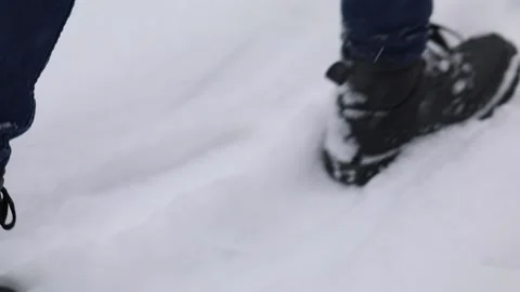 Boy walking in the snow leaving traces and footsteps behind Stock Footage 174748379