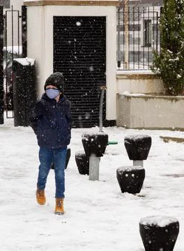 A boy walking in the snow Stock Photos
